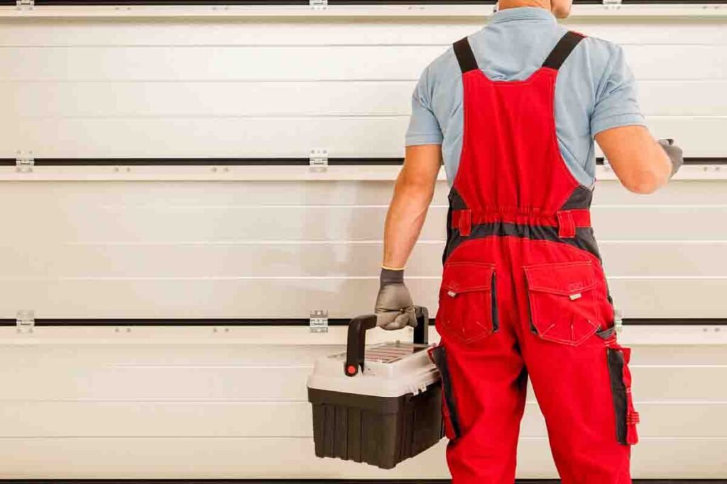 Set of garage door repair tools next to a commercial door
