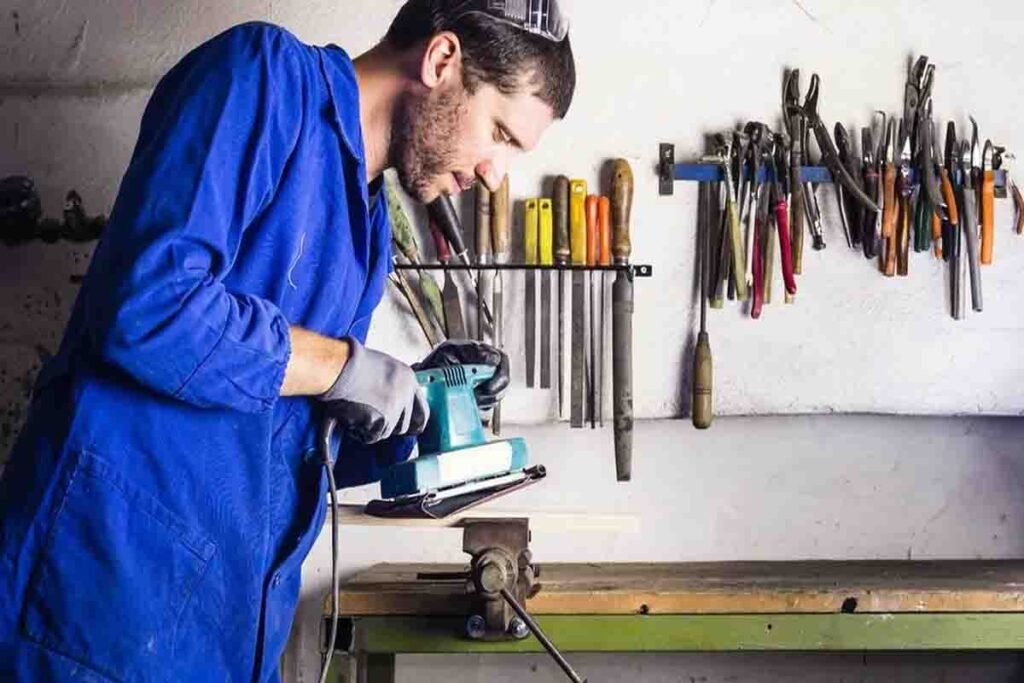 Technician using tools on a garage panel