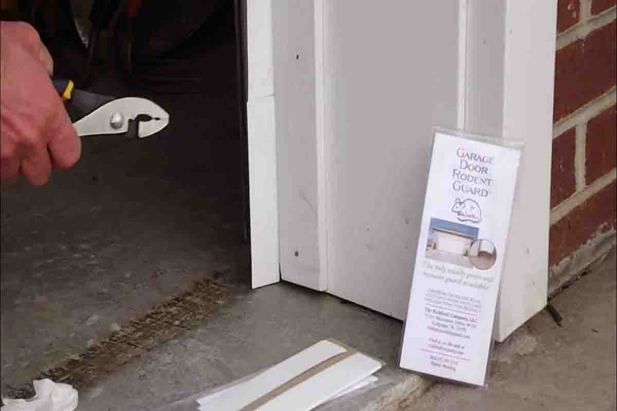 technician replacing garage door bottom seal