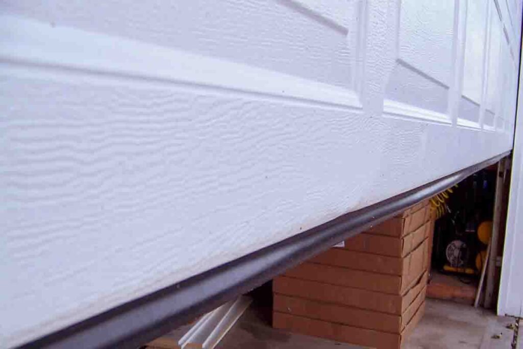 Damaged garage door bottom seal before replacement Pearland