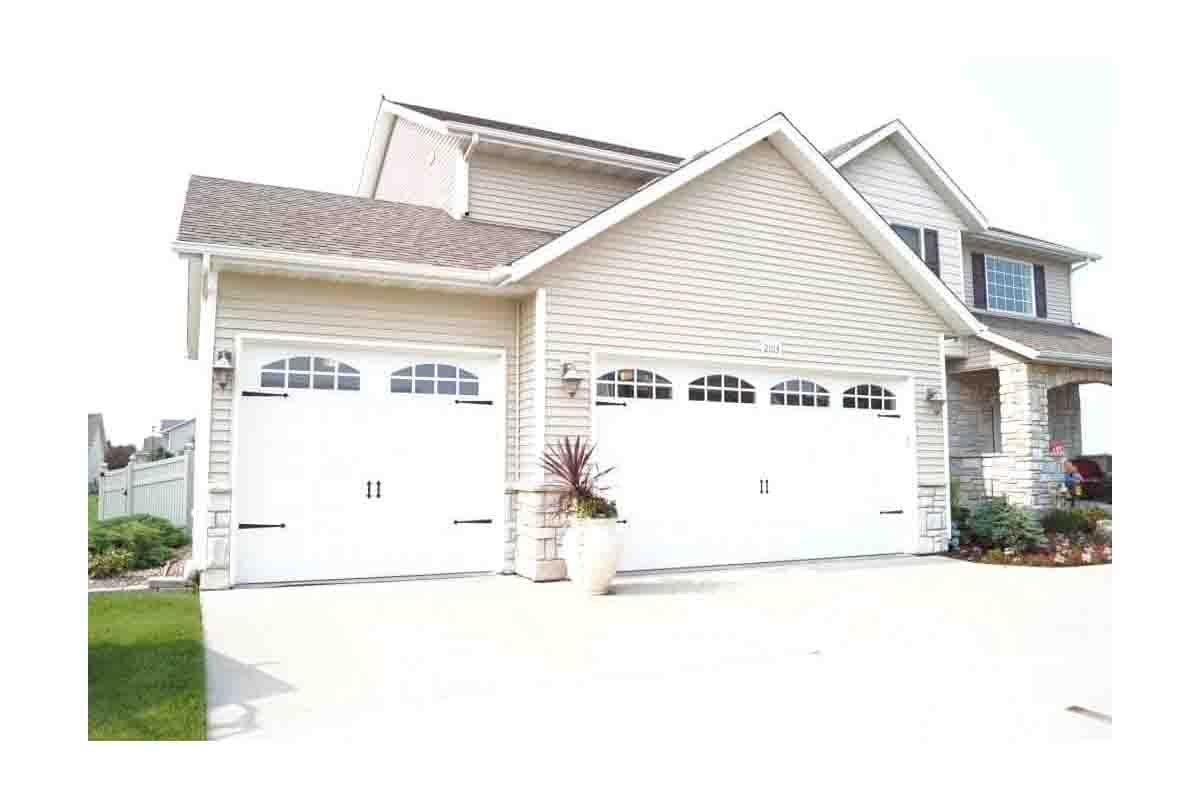 technician performing residential garage door tune up service
