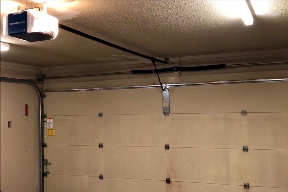 Comparison chart showing advantages and disadvantages of belt and chain garage door openers.
