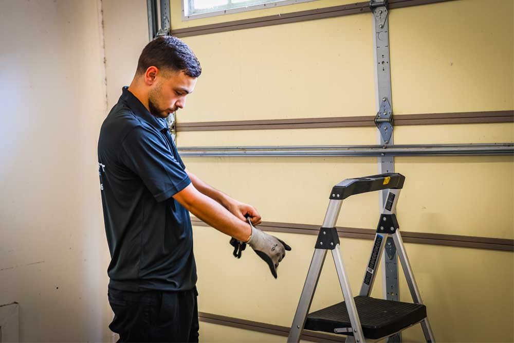 garage door repair technician working on a door in pasadena tx