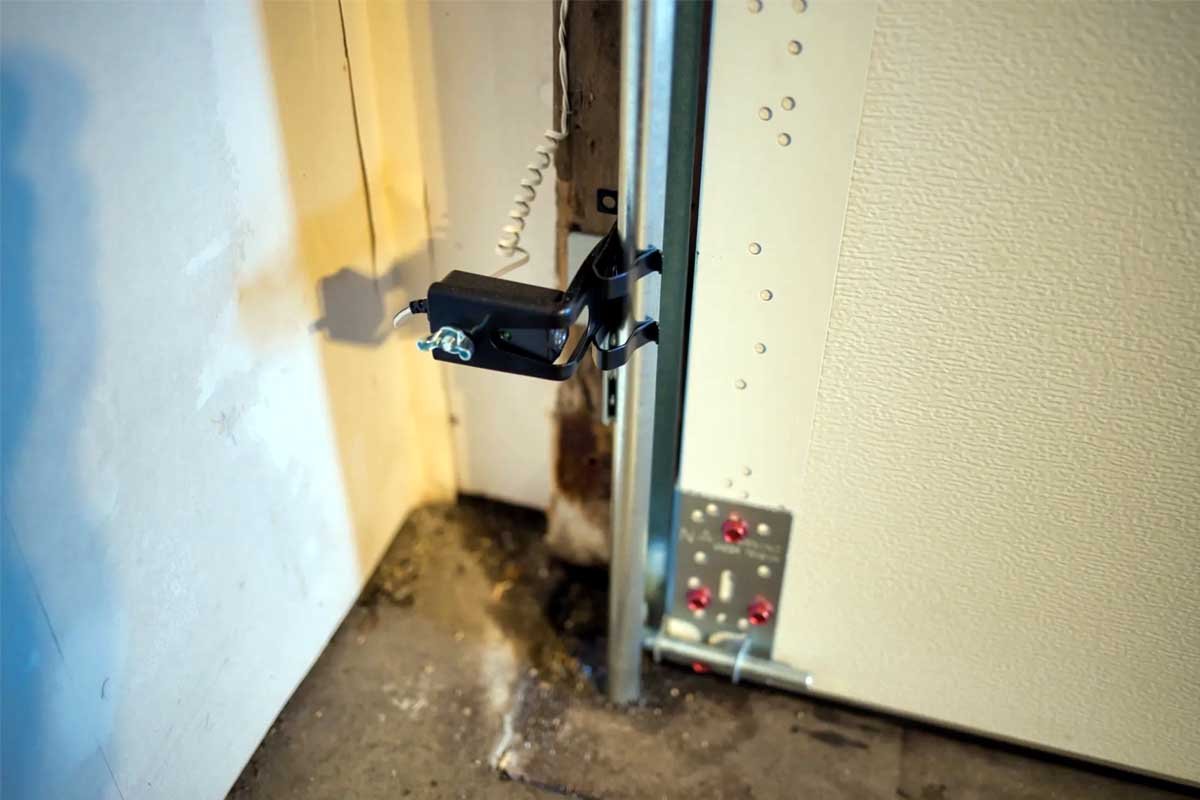 garage door sensor repair in pearland tx with technician adjusting sensor