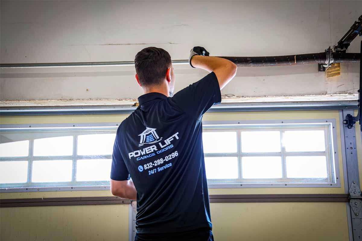 technician adjusting garage door springs for optimal performance