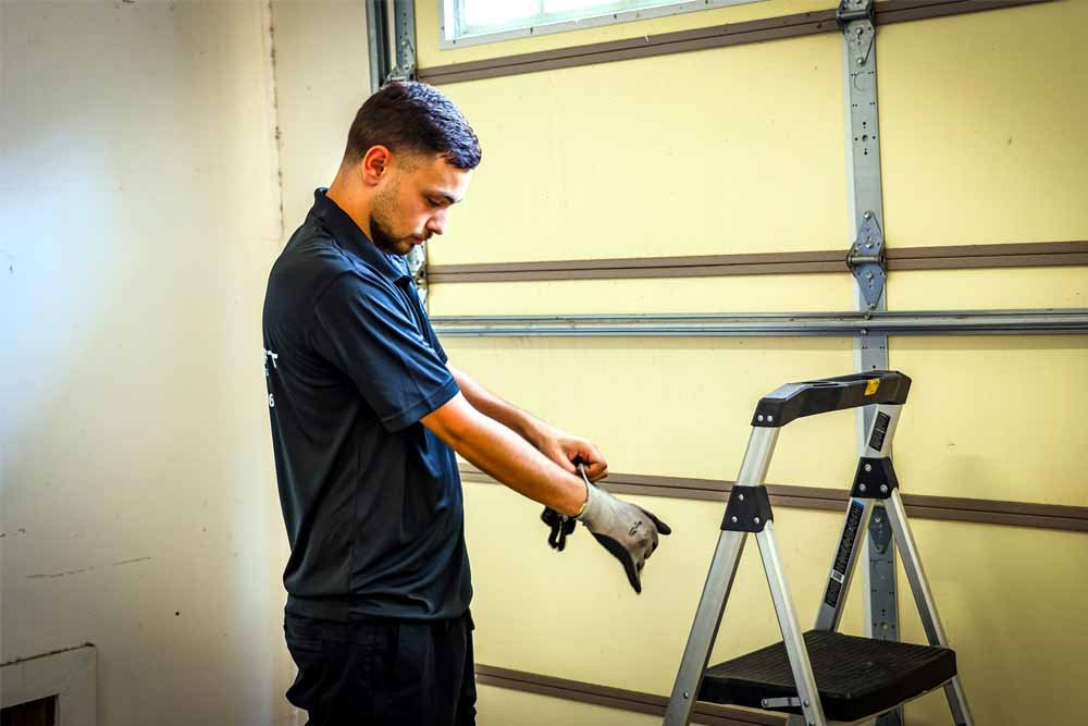 bent garage door spring being replaced with proper tools and safety measures