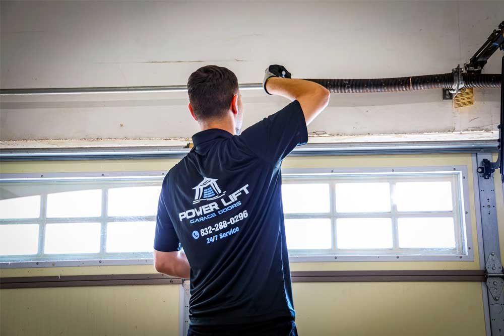 damaged garage door bottom seal showing gaps and wear